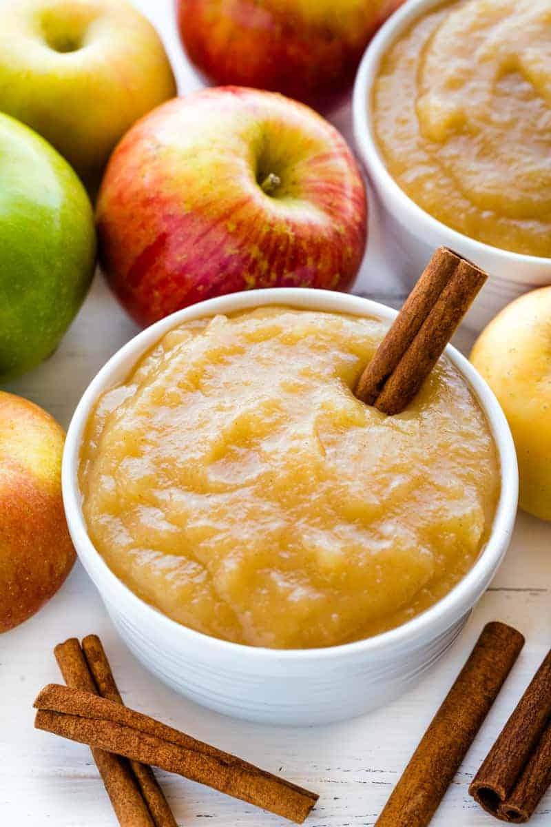 Learn all the secrets for How to Make Applesauce. Can it, freeze it -- leave it unsweetened, or add in some extras to sweeten things up. You'll only need one recipe to teach you everything you need to know! Applesauce in a white bowl with a cinnamon stick in it.