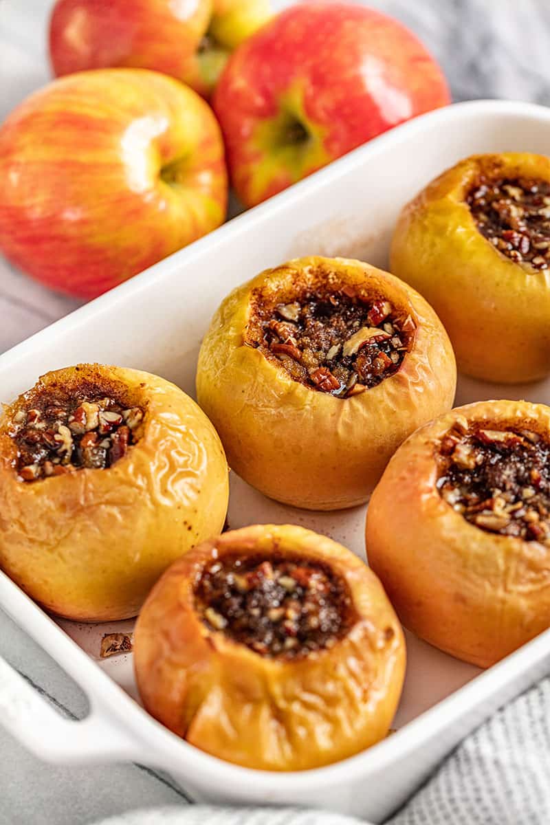 Classic Baked Apples are the perfect dessert for Fall.ย They are easy to make and are perfect for topping off with a scoop of vanilla ice cream. Baked Apples in a white baking dish.