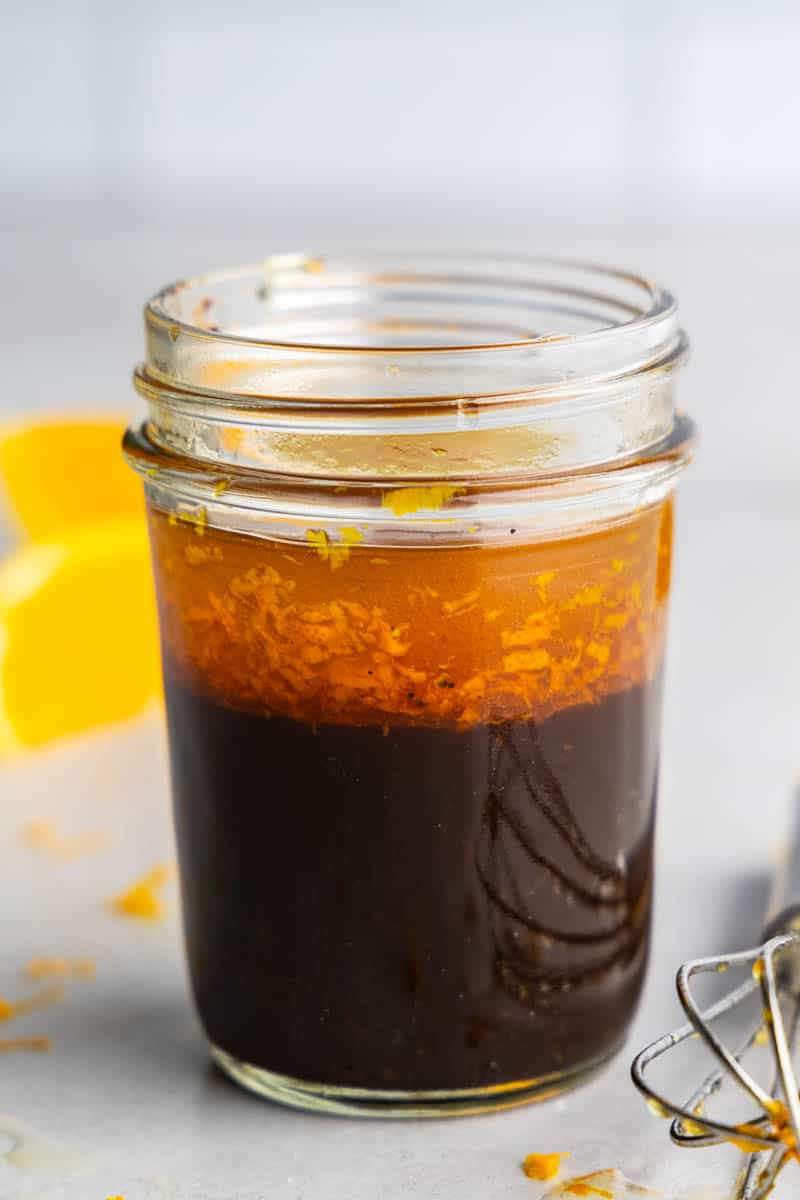ย The Best Beet Salad has goat cheese and an orange-balsamic vinaigrette. It's simple to make, and delicious!ย A close up view of a jar of orange balsamic vinaigrette salad dressing.